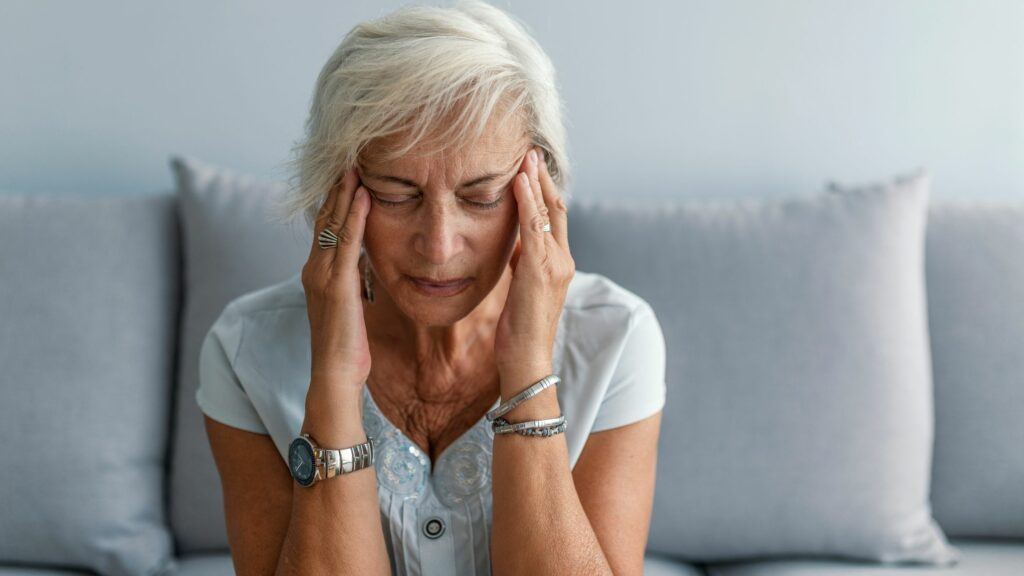 A women experiencing a severe headache that may be linked to her consumption of dairy 