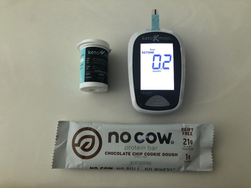No Cow protein bar next to a Keto-Mojo ketone meter reading 0.2